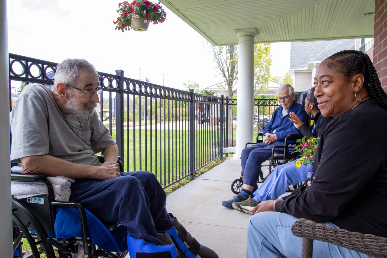 Residents and staff connecting on the Belmar porch